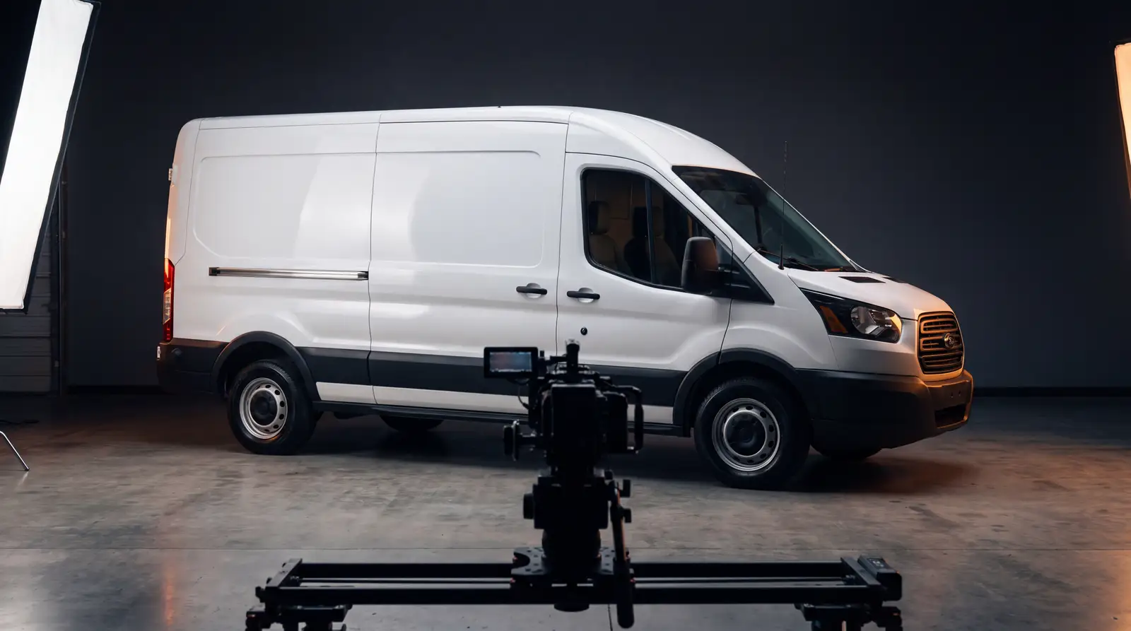 A contractor van lit like a commercial shoot inside a warehouse